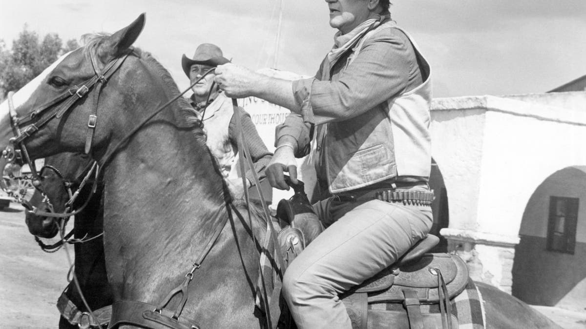 John Wayne on horseback in a scene from Rio Lobo