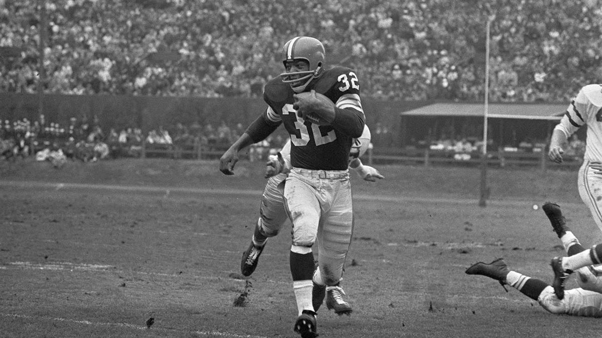 Jim Brown runs for a first down