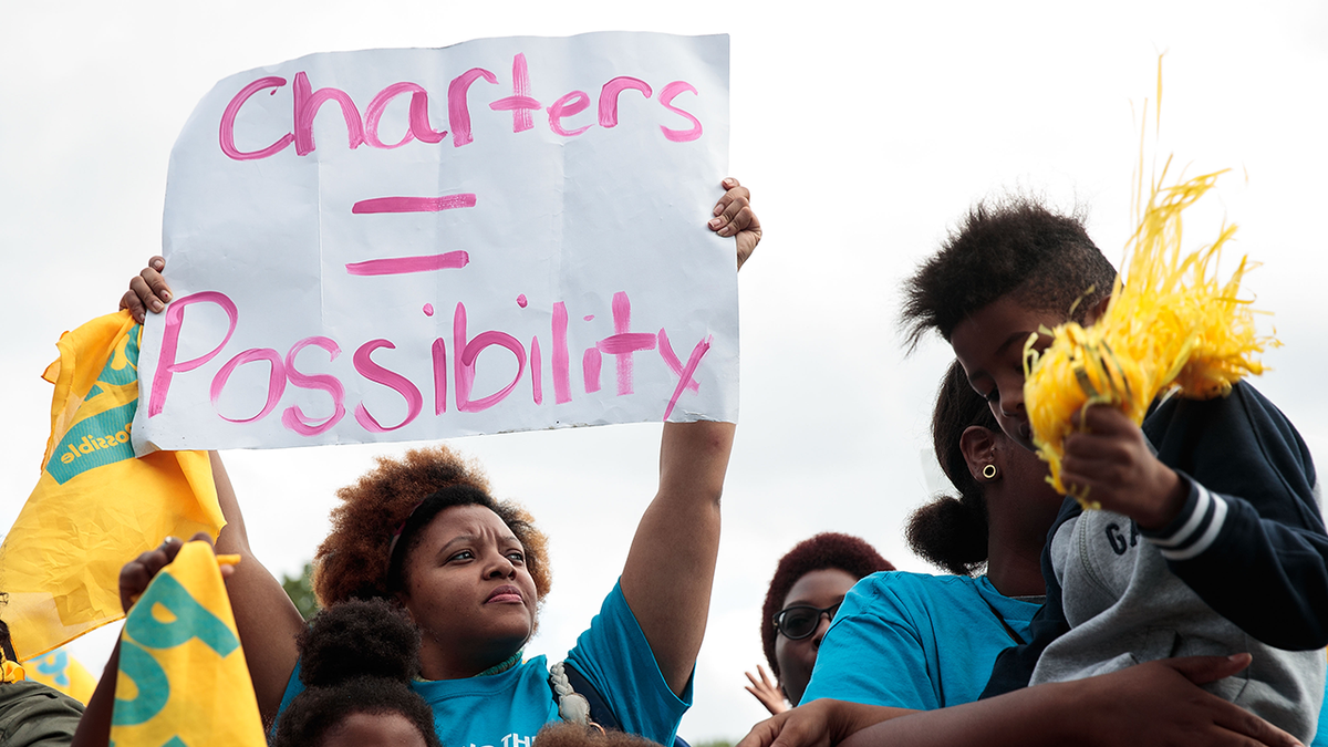 A woman with a school choice protest sign