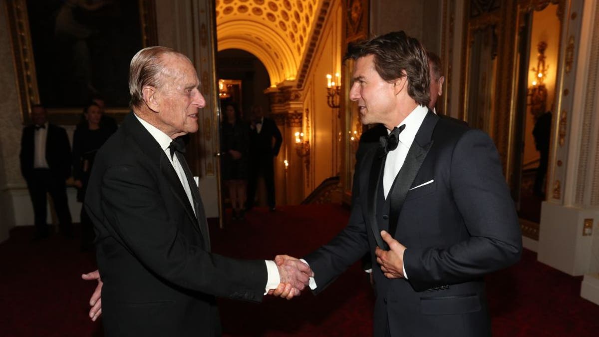 prince philip shaking hands with tom cruise