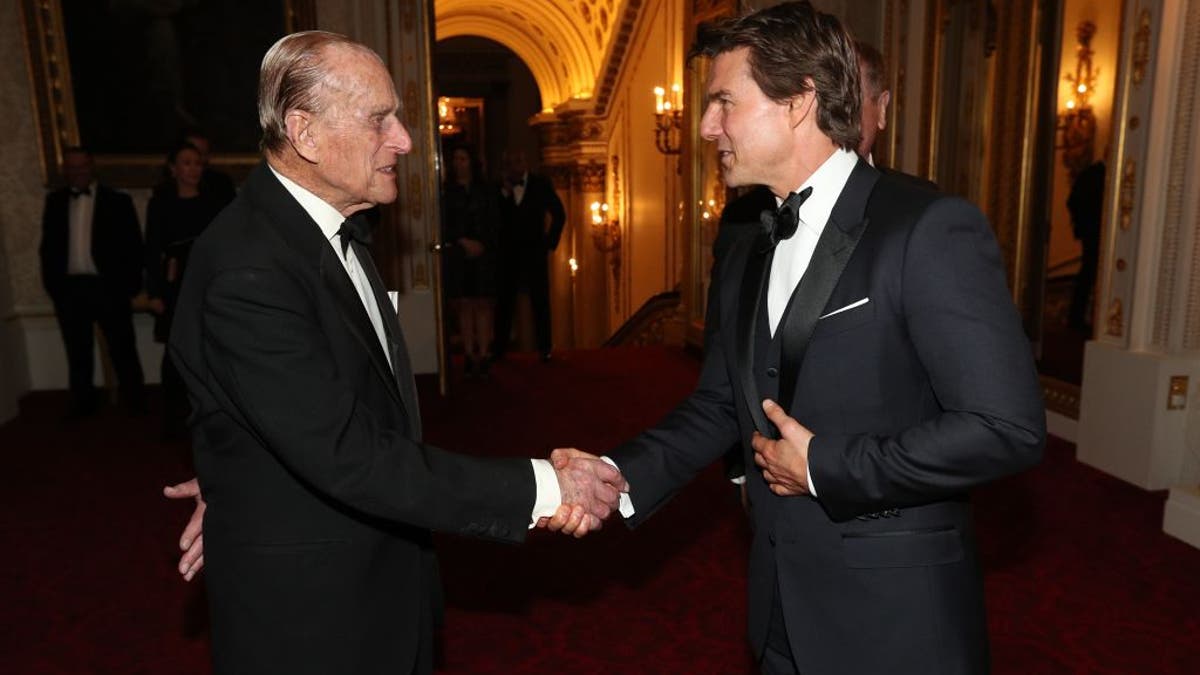 prince philip shaking hands with tom cruise