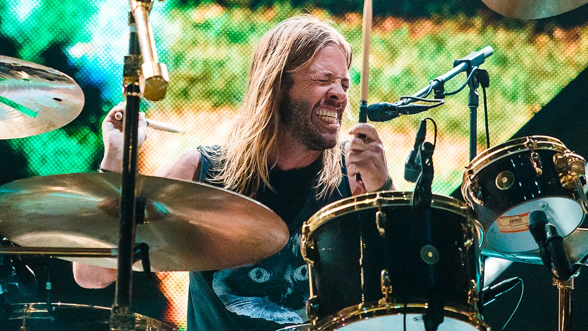 With his eyes closed Taylor Hawkins passionately plays the drums on stage