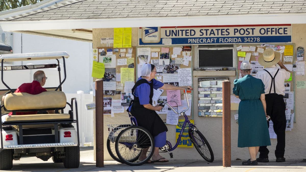 Members of the Amish stand outside a Florida post office.