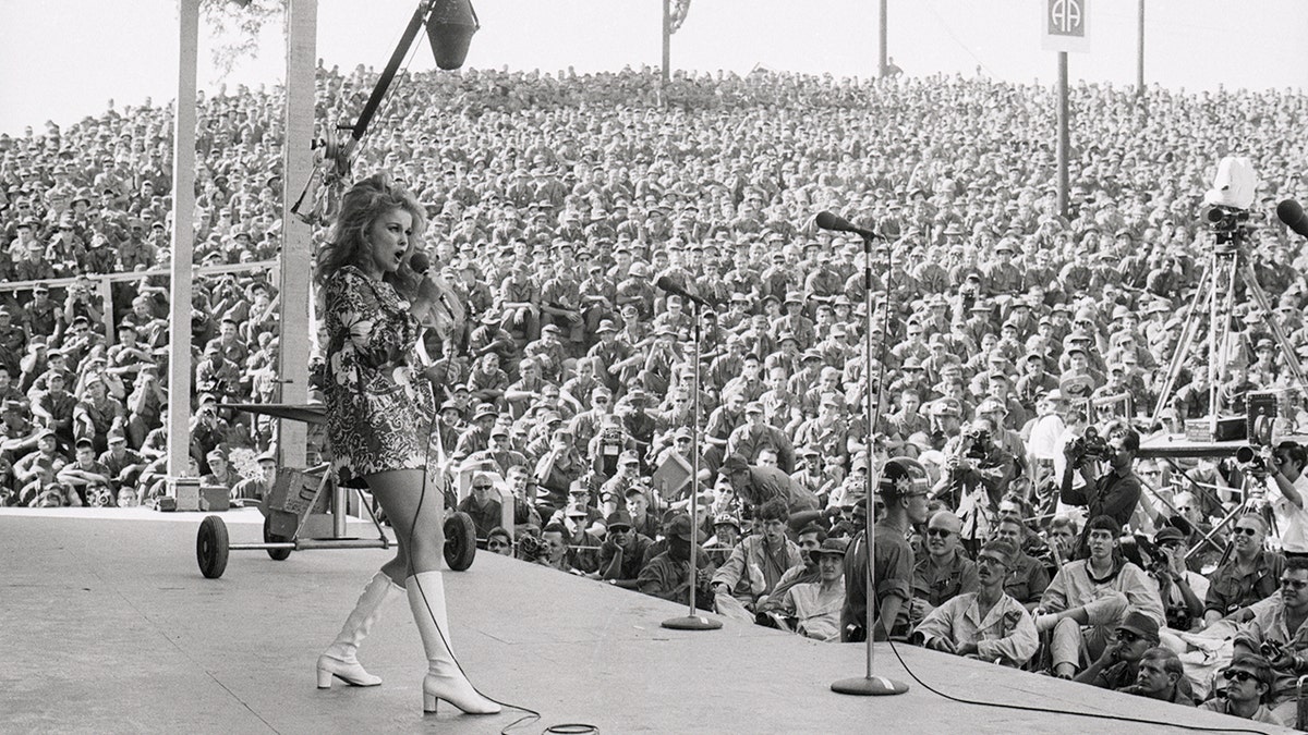 Ann-Margret dancing on stage in a short dress in front of GIs