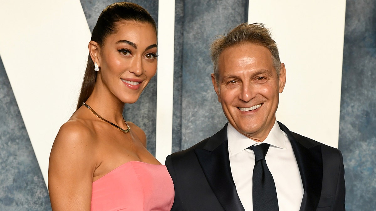 Sarah Staudinger in a pink strapless dress and Ari Emanuel in a suit and tie