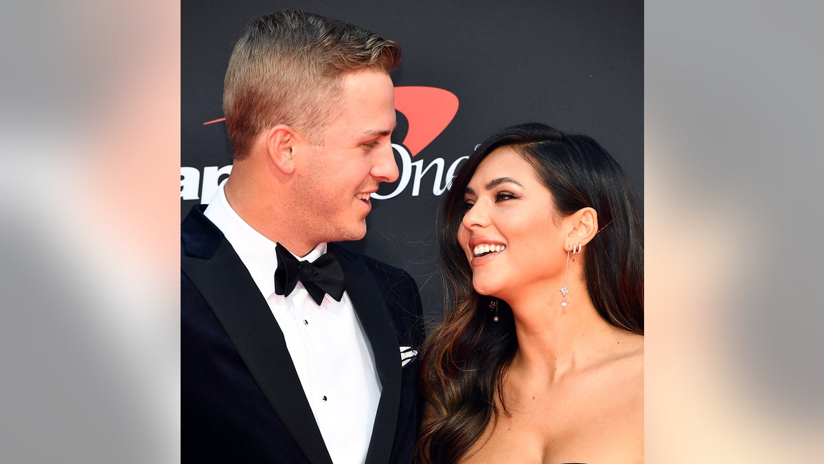 A close-up of Jared Goff and Christen Harper looking at each other on the red carpet