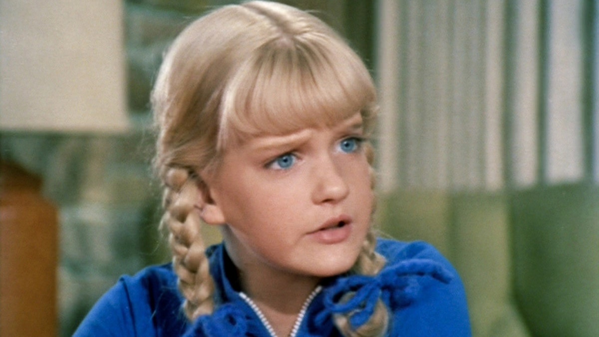 A close-up of Susan Olsen as Cindy Brady wearing a blue shirt