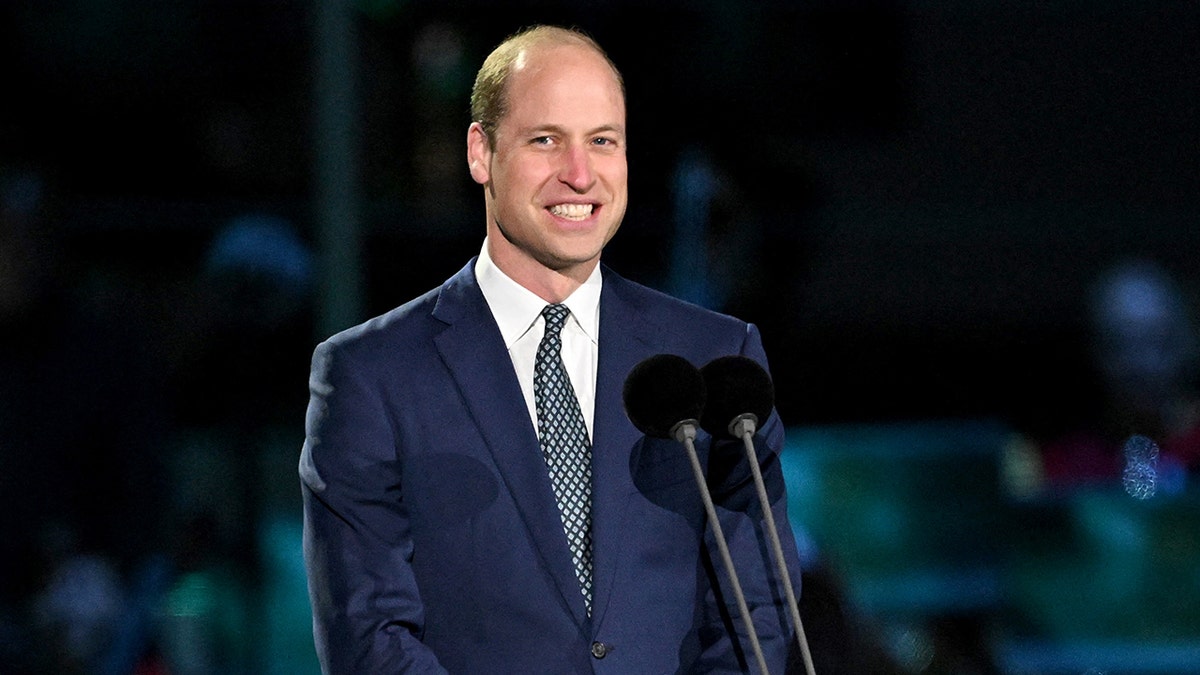 Prince William smiling on stage