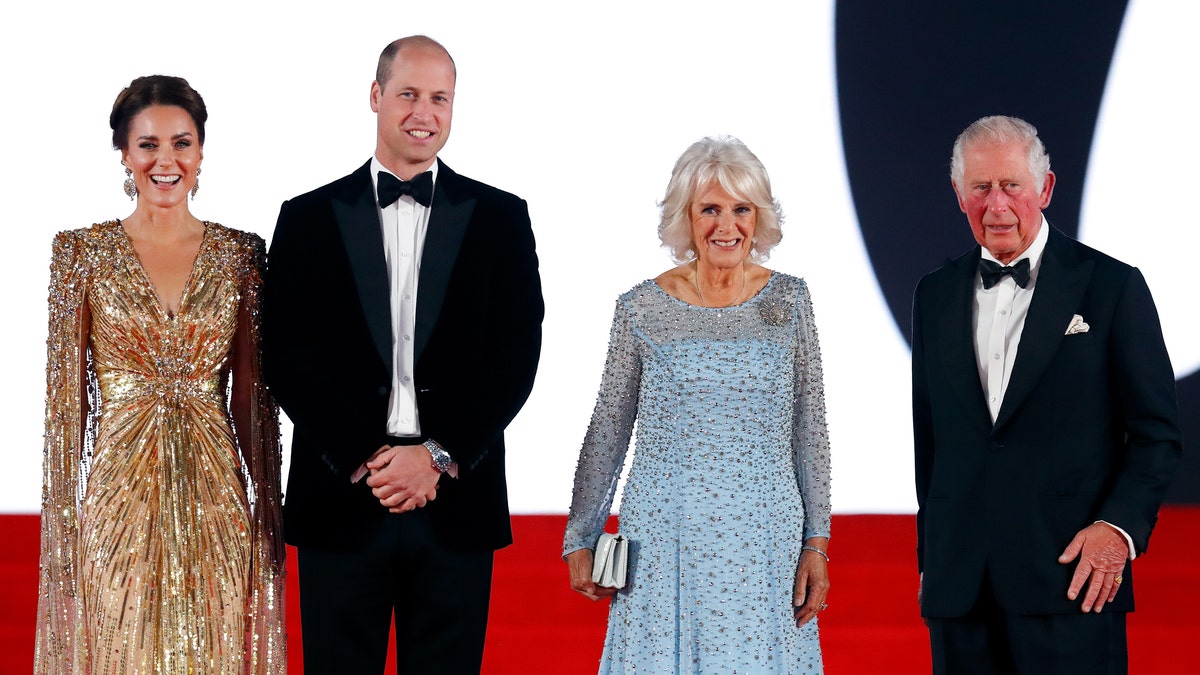 Kate Middleton in a shimmering gold dress, Prince William in a tuxedo, Queen Camilla in a light blue gown and King Charles in a tuxedo
