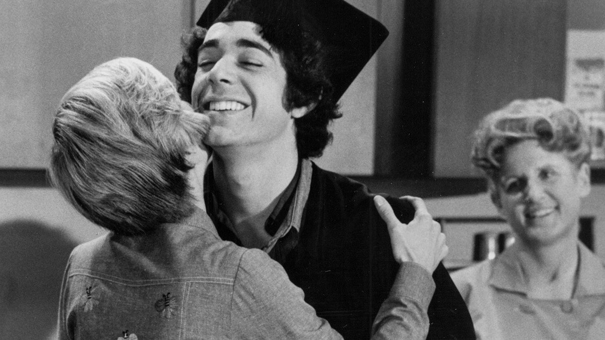 Barry Williams being embraced by Florence Henderson