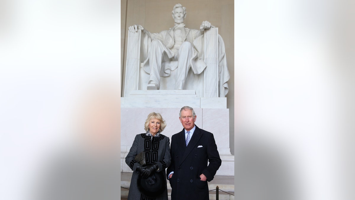King Charles and Queen Camilla posing in front of a statue of Abraham Lincoln in Washington