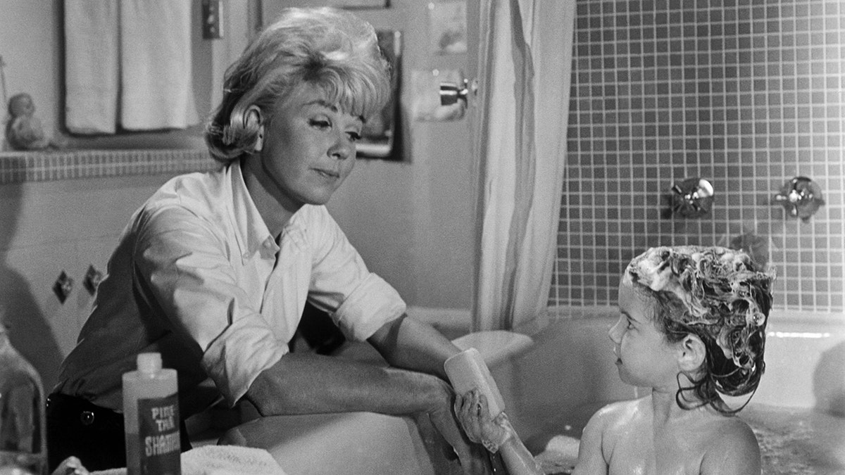 Doris Day giving a toddler Kym Karath a bath