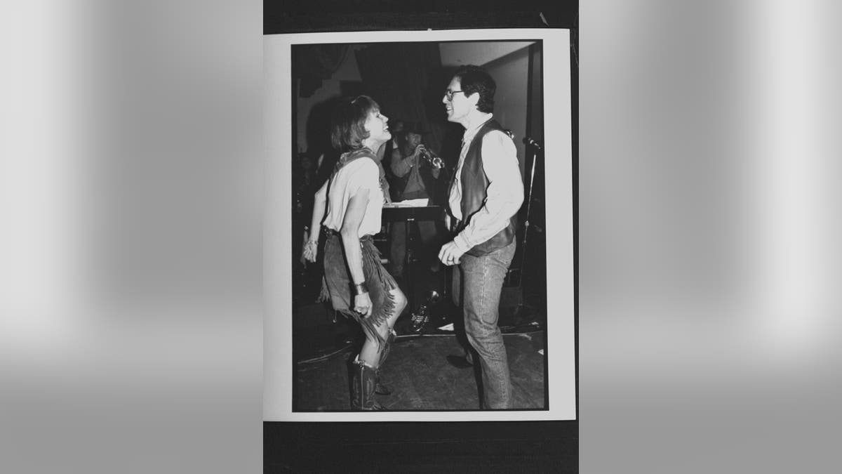 A black and white photo of Mary Tyler Moore dancing with her husband Dr. Robert Levine