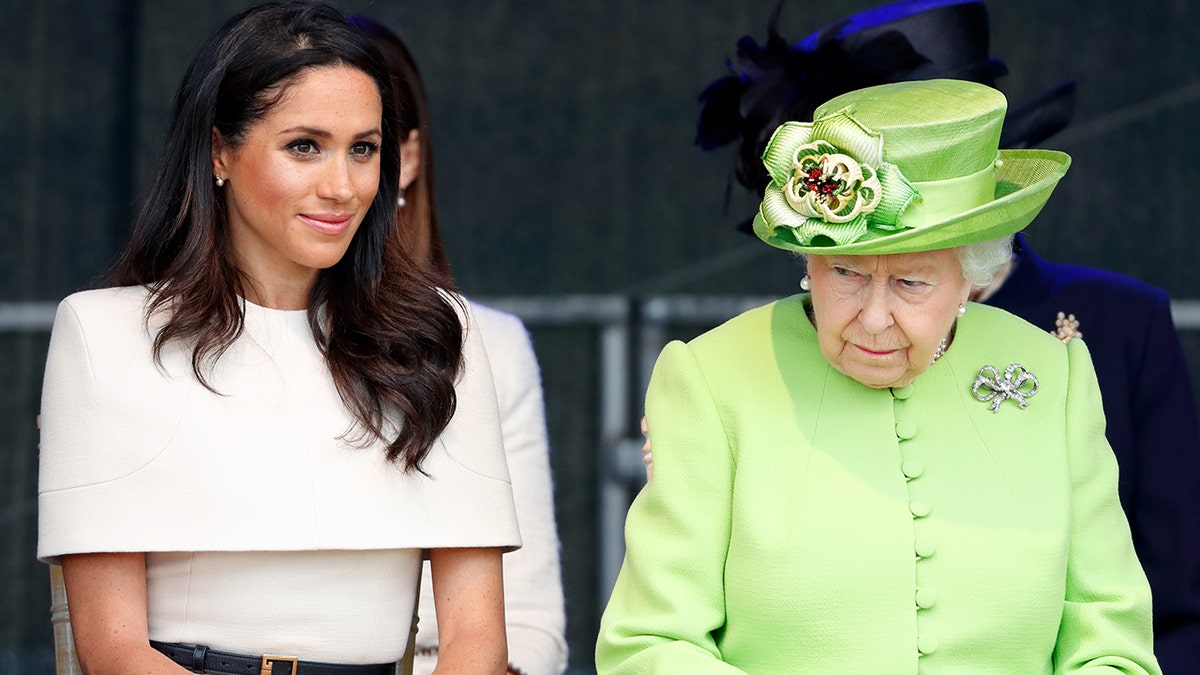 Meghan Markle in a beige dress sitting next to Queen Elizabeth in a lime green dress
