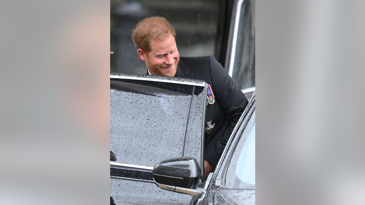 Prince Harry in his morning suit entering a black car