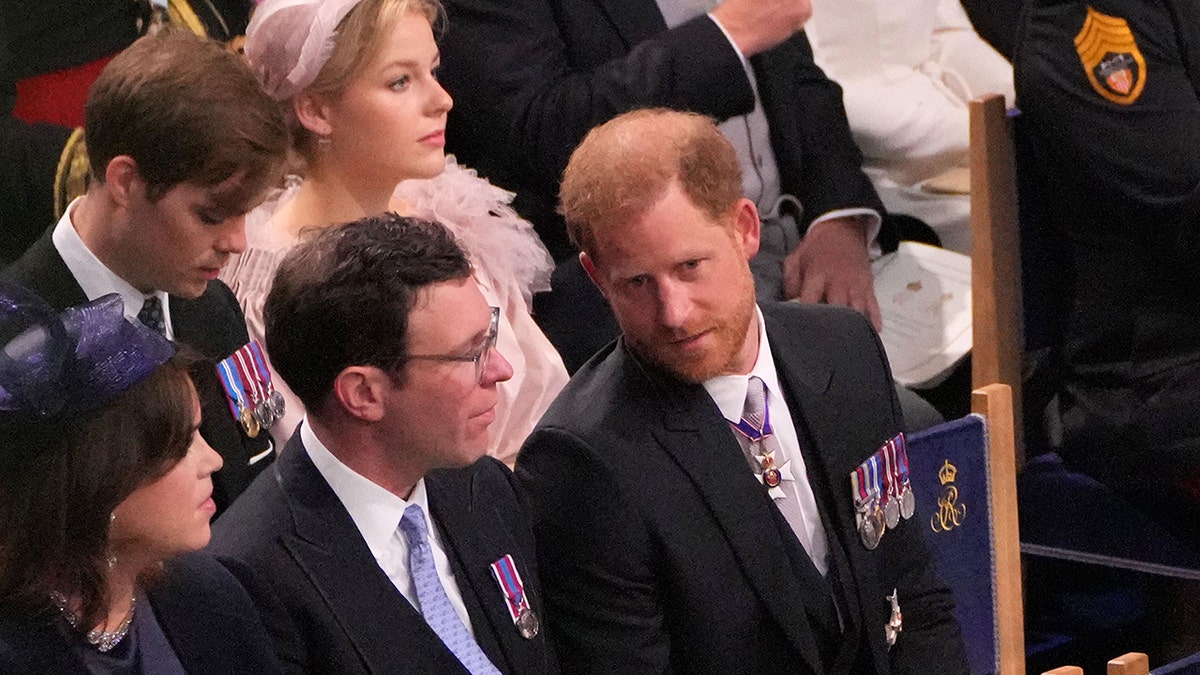 Prince Harry in his morning suit chatting with Jack Brooksbank