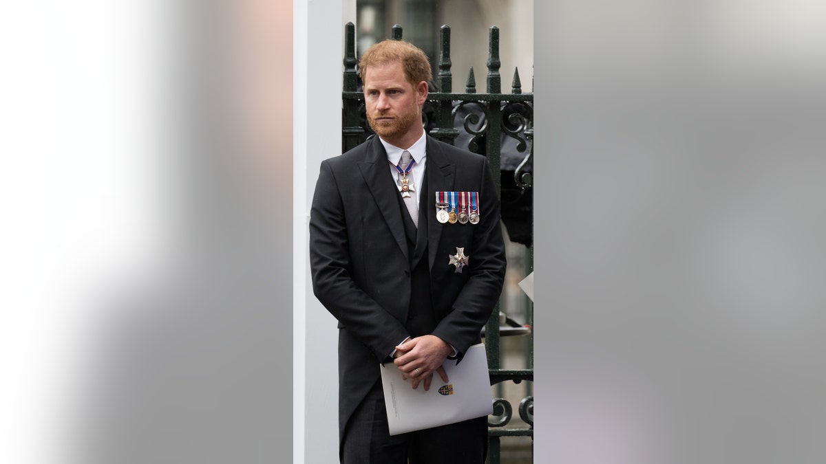 Prince Harry standing in his morning suit