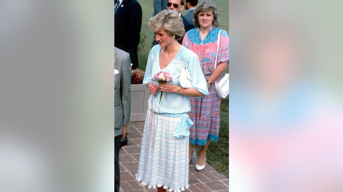 Princess Diana in a light blue and pink dress