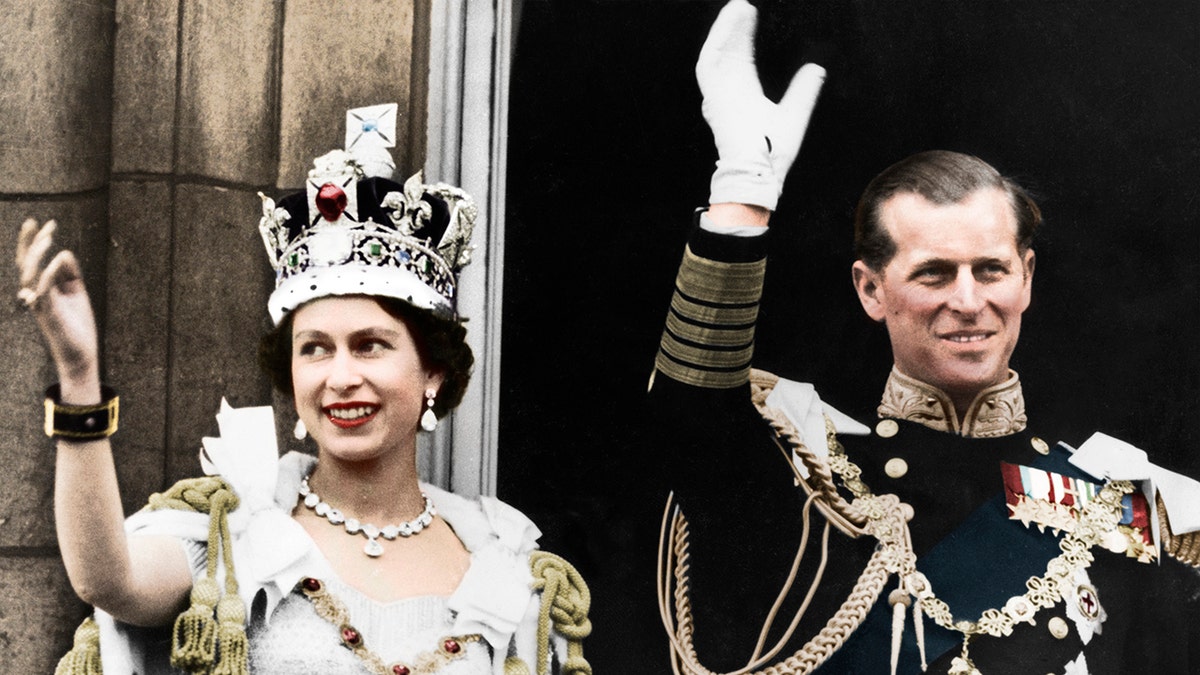 Queen Elizabeth in royal regalia waving alongside Prince Philip in traditional garb