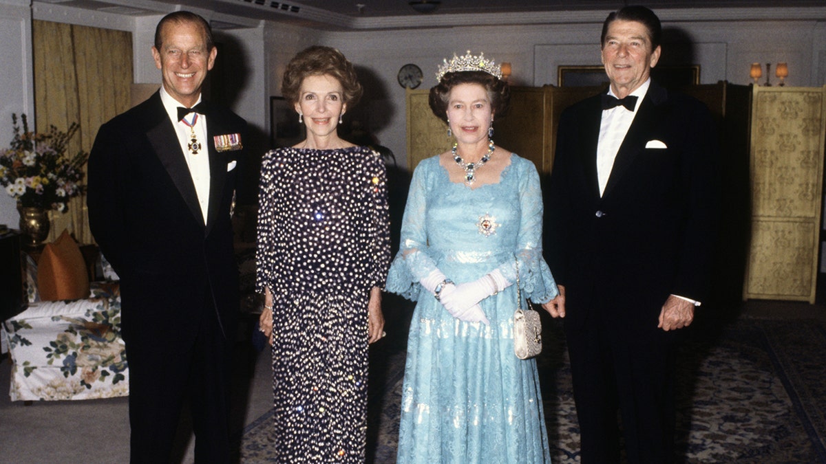 Prince Philip, Nancy Reagan, Queen Elizabeth and Ronald Reagan posing together at a banquet
