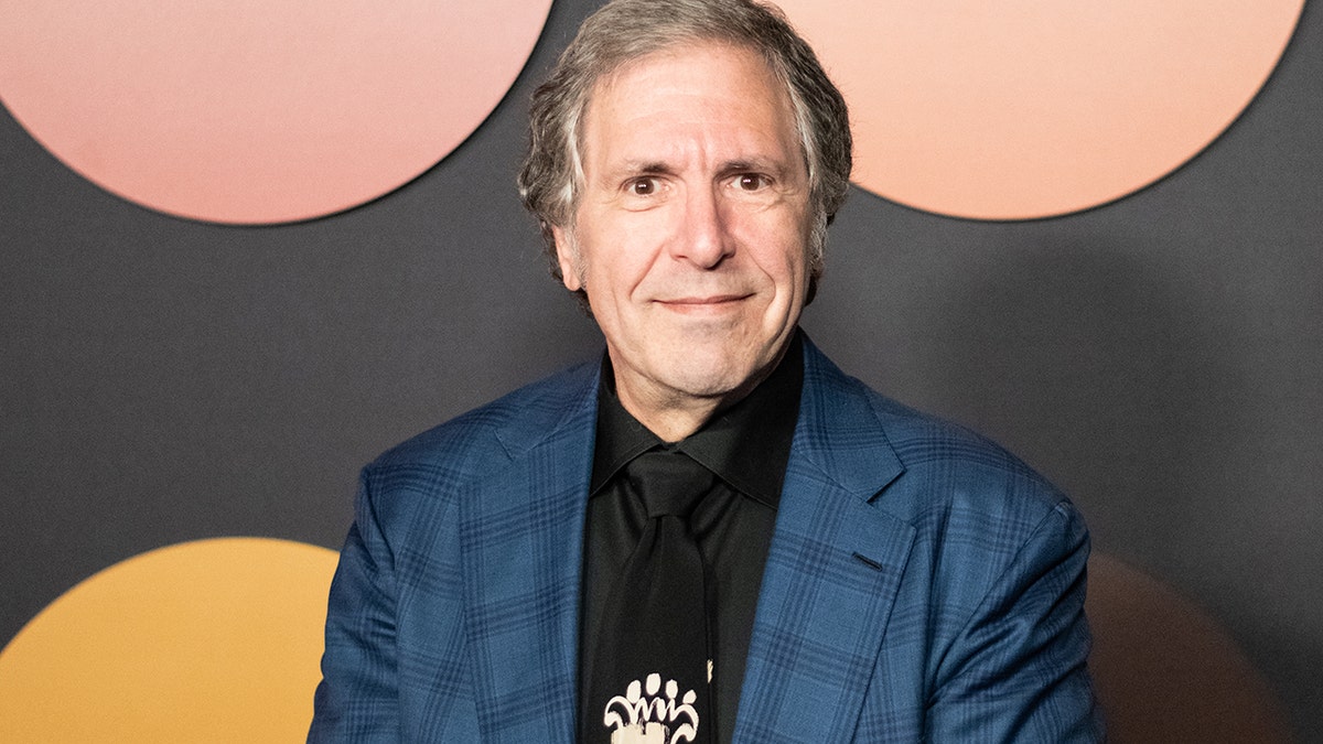 Robert Levine wearing a blue blazer and black shirt