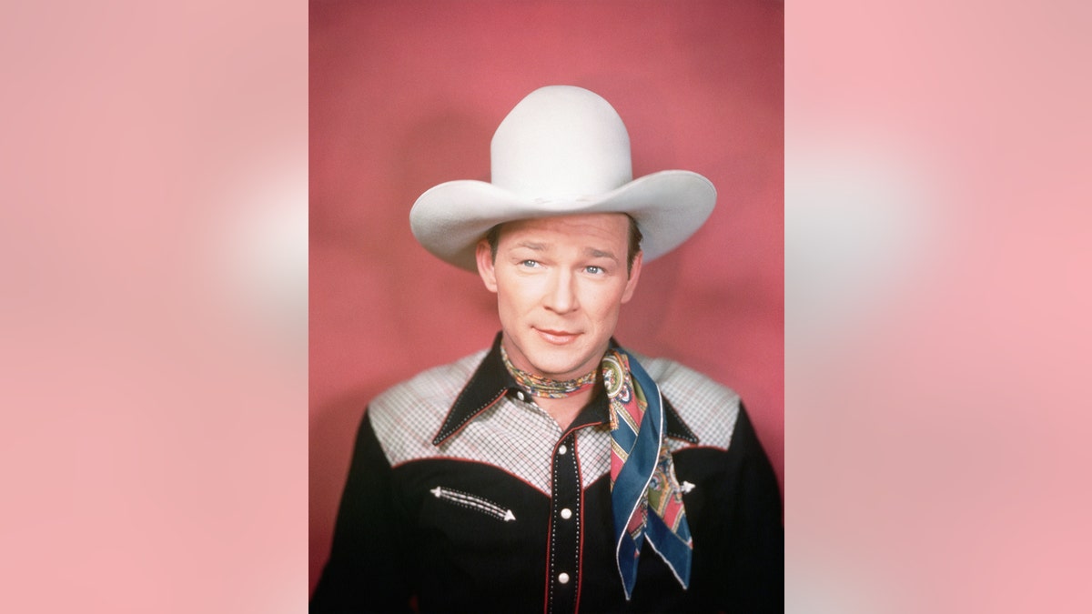 a close-up of Roy Rogers wearing a cowboy hat and a scarf
