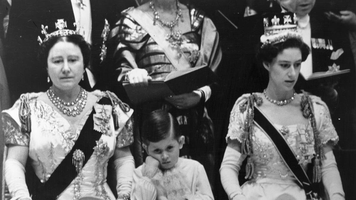 Prince Charles looking tired in between his grandmother and aunt during his mothers coronation