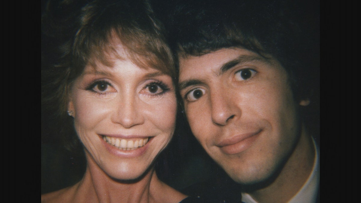 A close-up of Mary Tyler Moore smiling next to Robert Levine