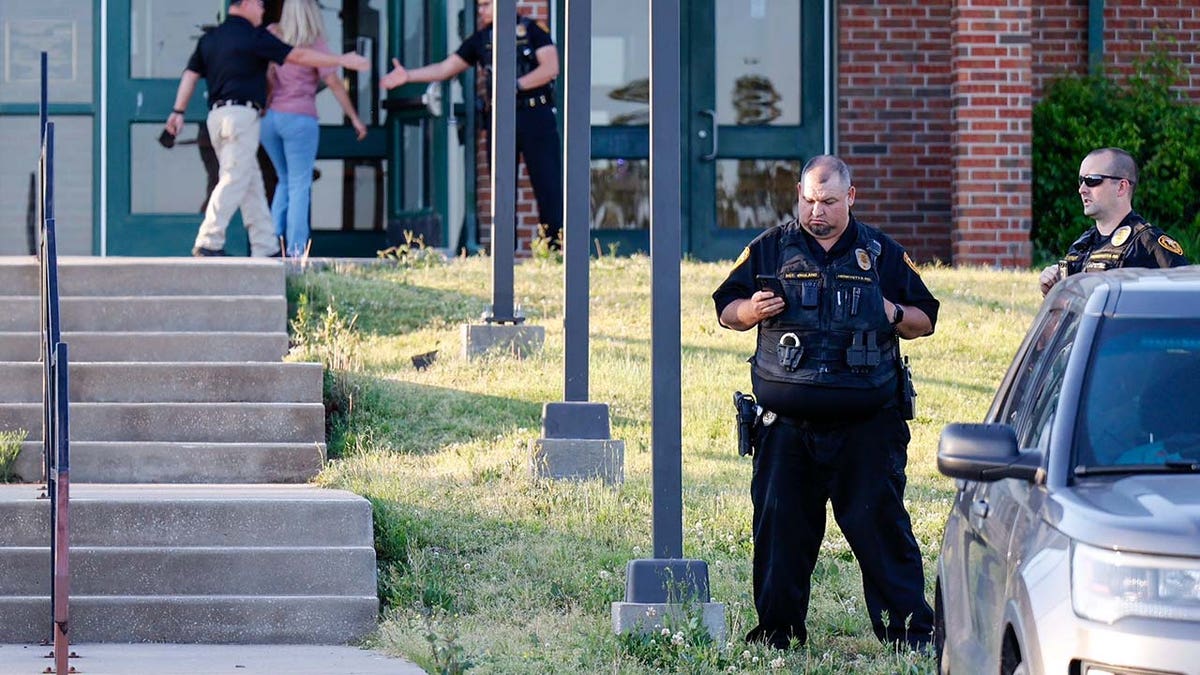 Law enforcement stand outside of Henryetta High School