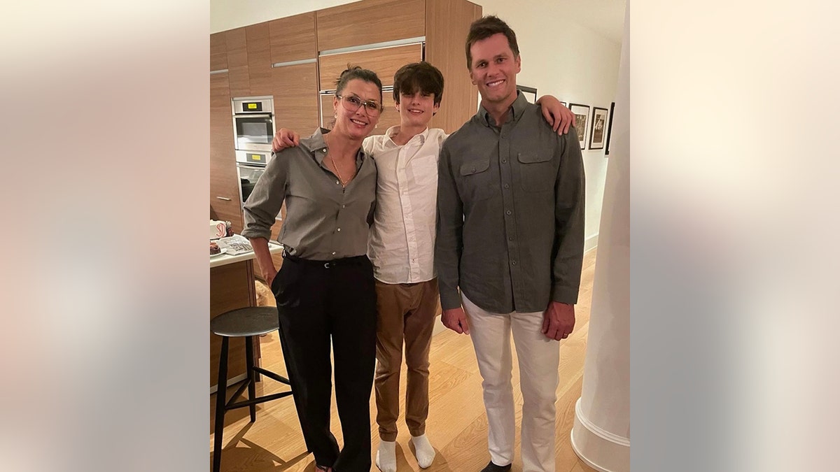 Tom Brady smiles for a photo with his son Jack, nearly as tall as him, with his mother Bridget Moynahan