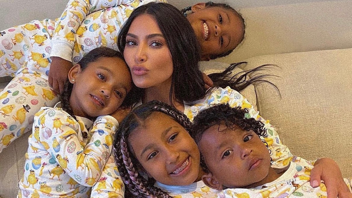 Kim Kardashian snuggles up with her four children: North, Saint, Chicago, and Psalm all wearing matching pajamas for Easter