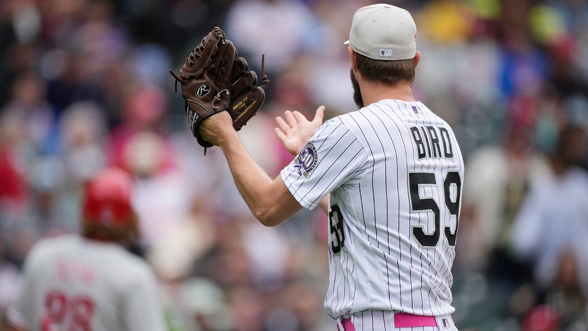 Jake Bird claps at the dugout