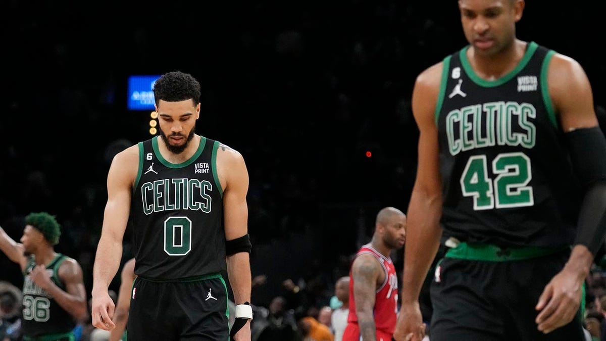 Celtics players walk off the court