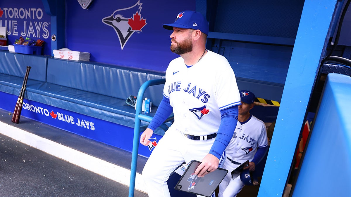 Jordan Romano of the Toronto Blue Jays walks into the dugout prior