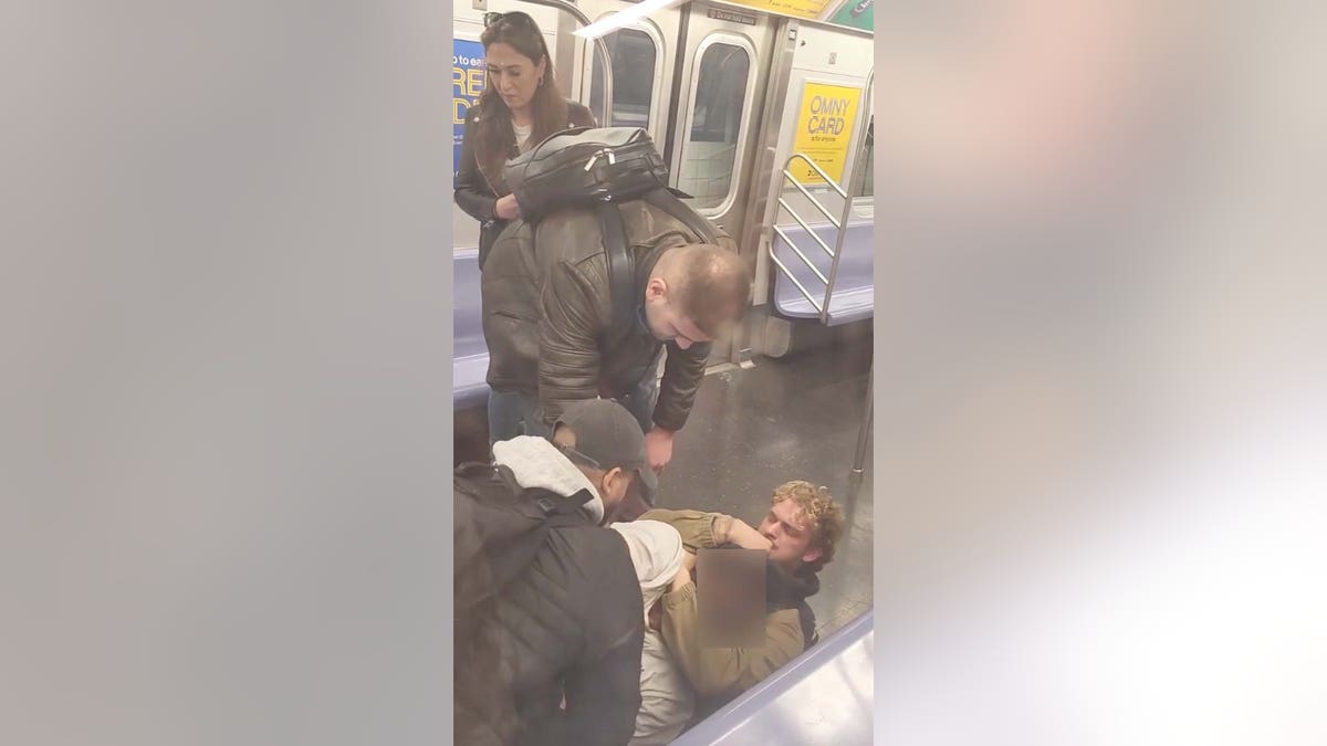 Screenshot from bystander video showing Jordan Neely being held in a chokehold on the New York City subway.