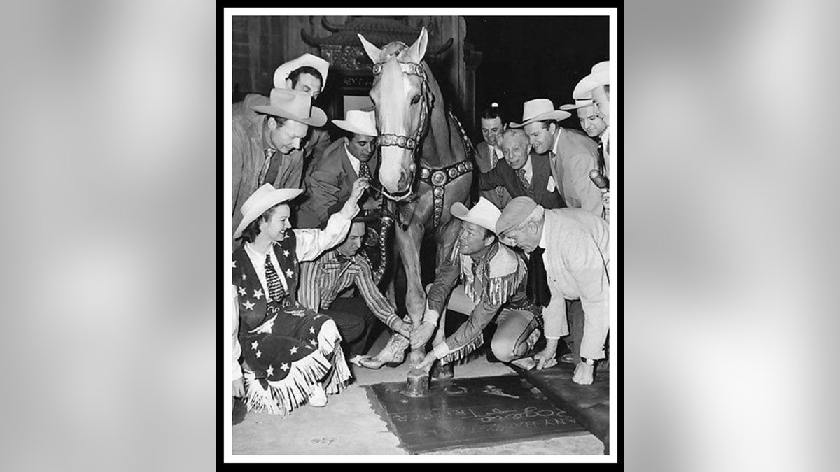 Roy Rogers posing with his horse Trigger