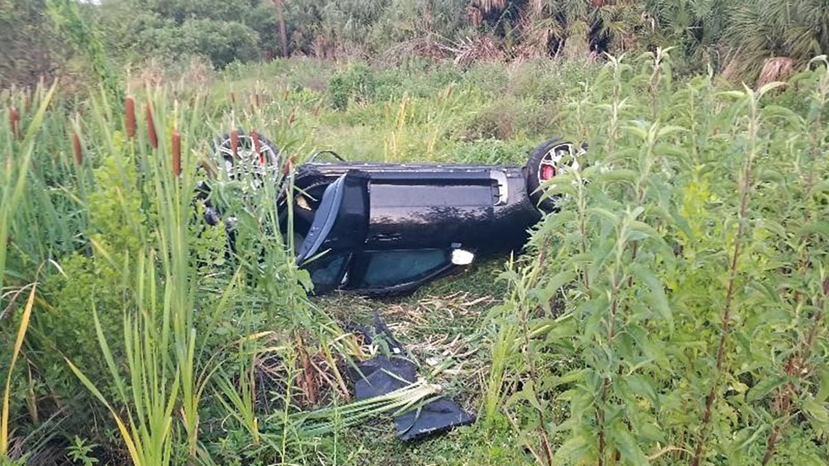 KIA flipped over in grass