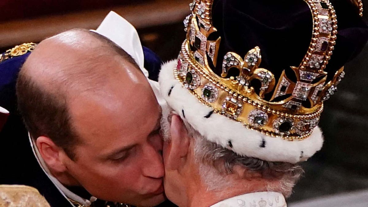 Britains William, the Prince of Wales kisses his father King Charles III