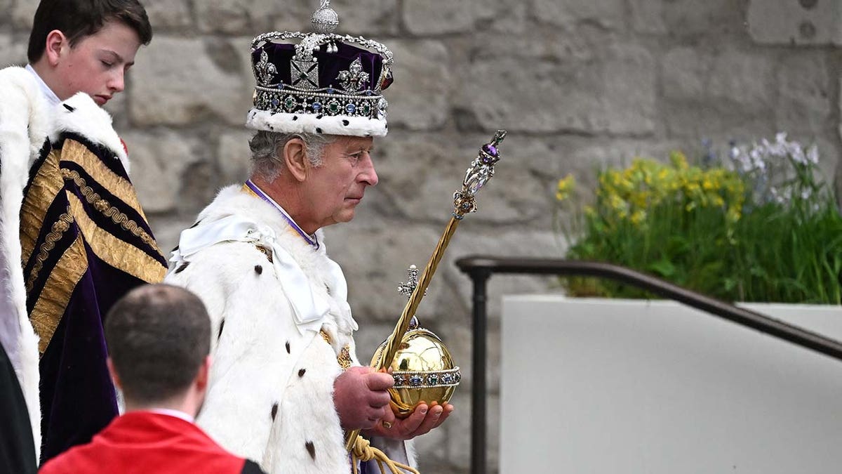 King Charles wearing a purple crown during his coronation ceremony