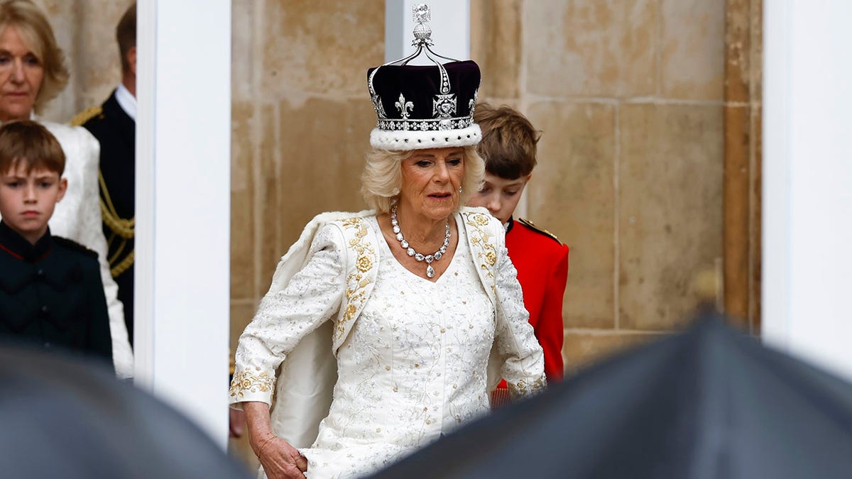 Camilla wearing a white goiwn with a crown