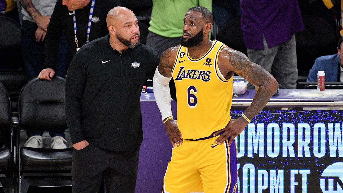 LeBron James talks to coach Darvin Ham