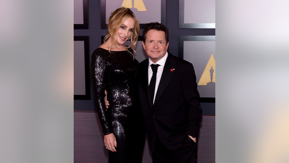 Michael J. Fox smiling with Tracy Pollan