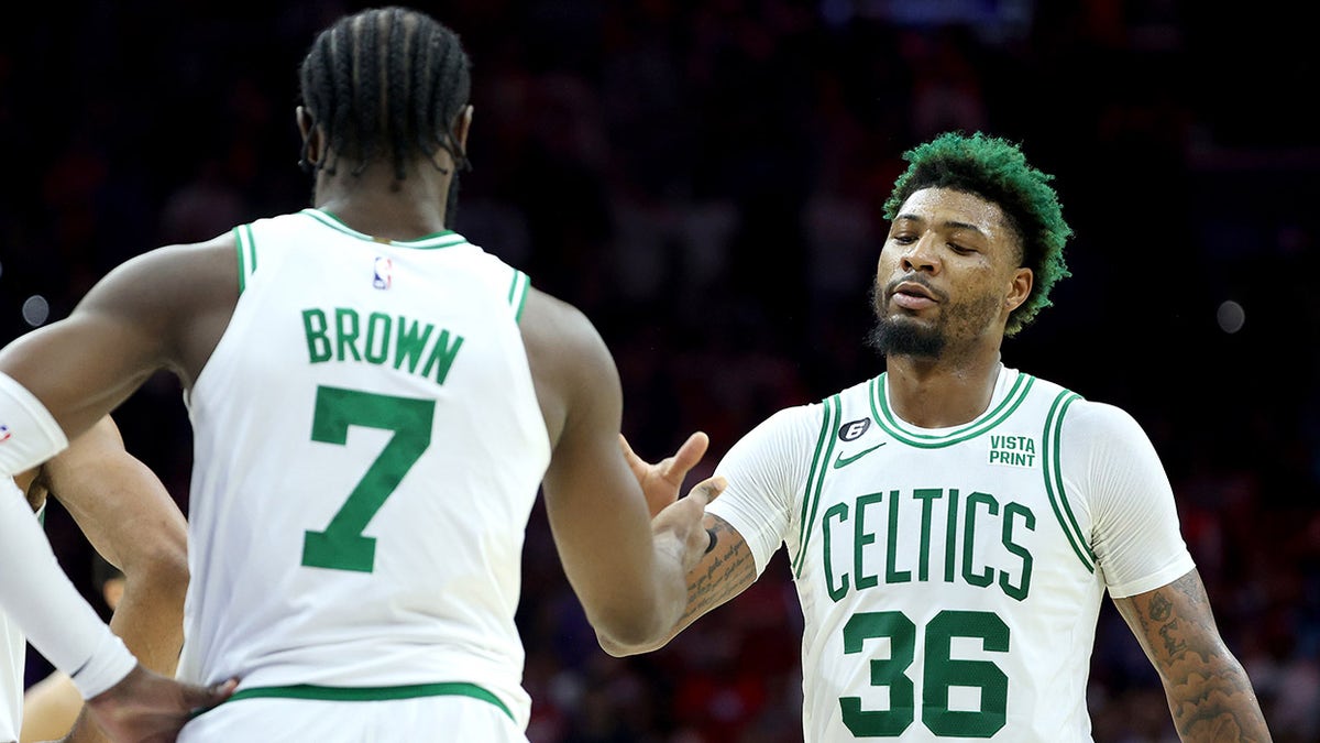 Marcus Smart high fives Jaylen Brown