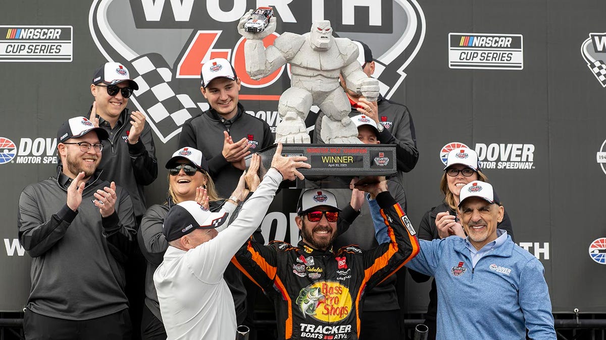 Martin Truex Jr holds the trophy