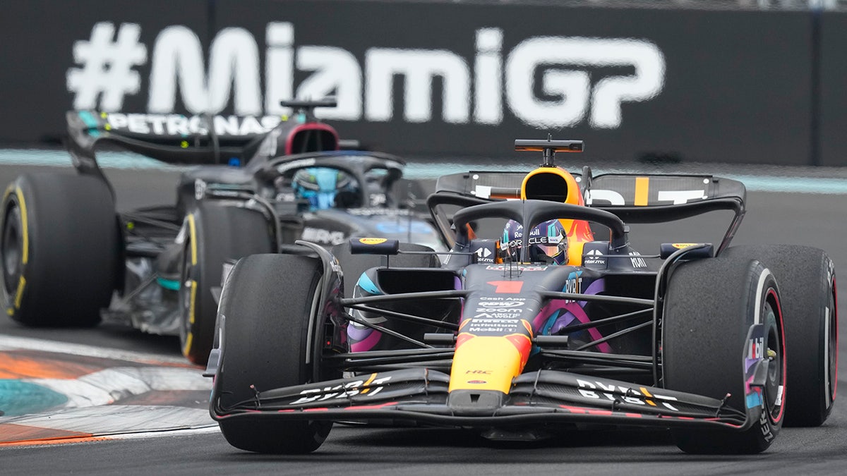 Max Verstappen battles George Russell