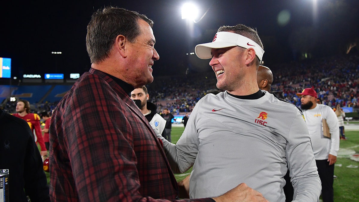 Mike Bohn celebrates with Lincoln Riley