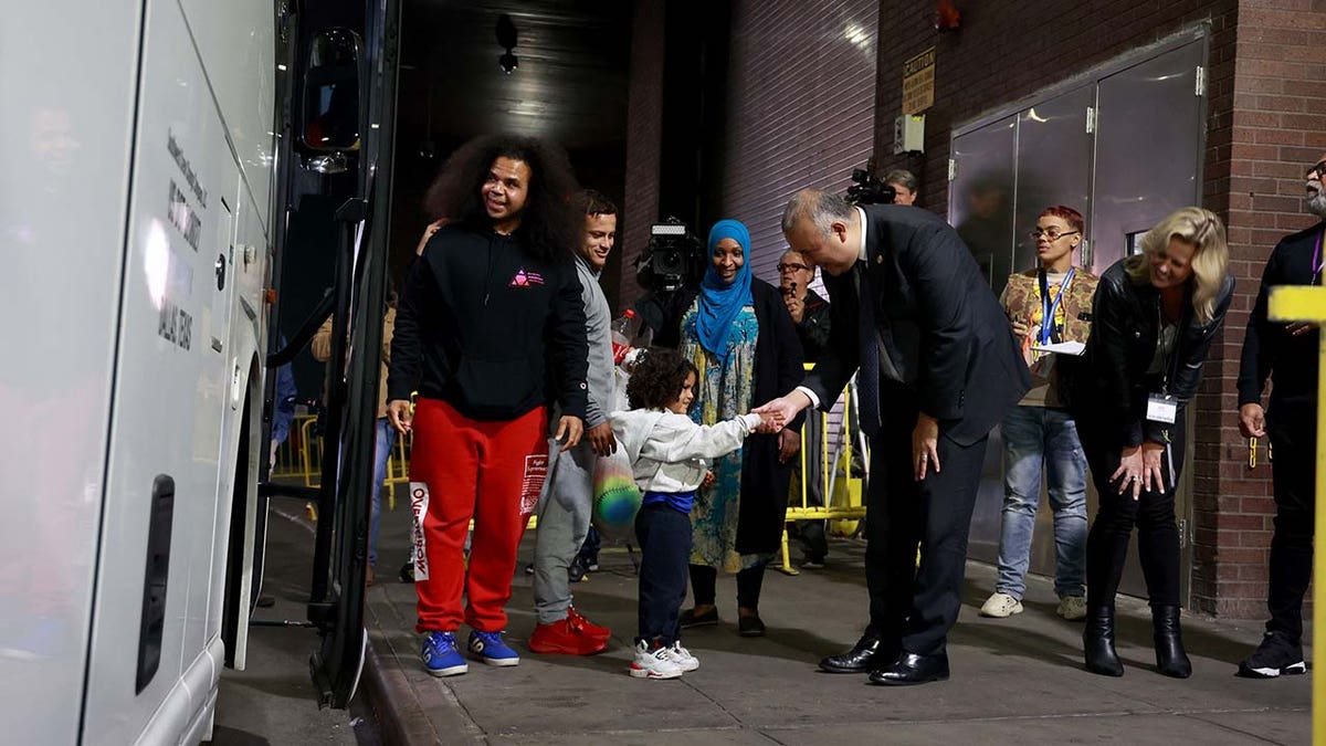 New York City Mayor's Office of Immigrant Affairs Commissioner Manuel Castro (center), welcomes migrants arriving at the Port Authority Bus Terminal