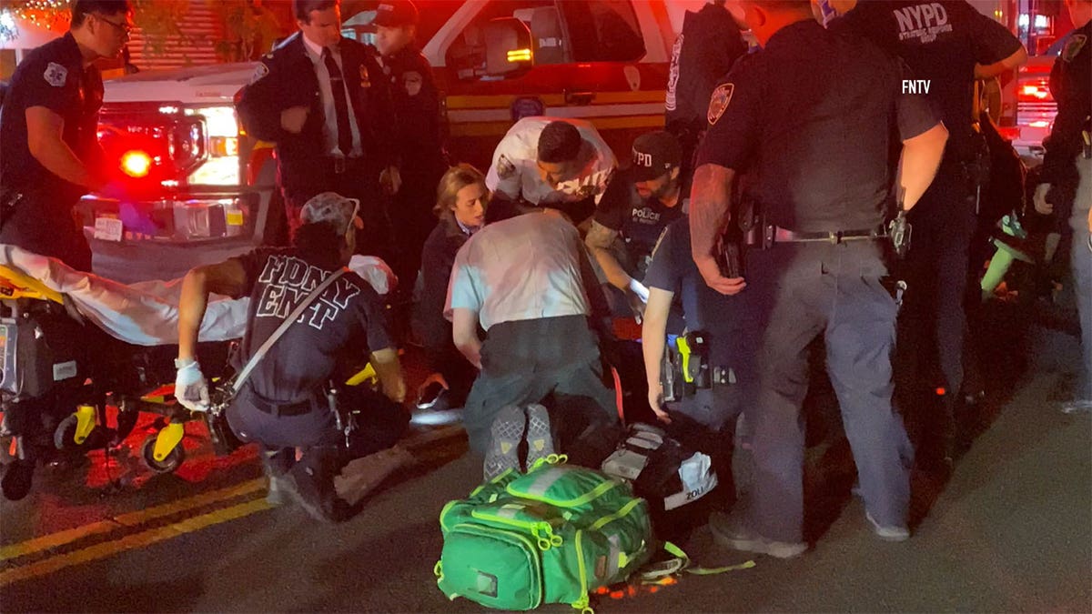 EMTs on the street helping injured officers.