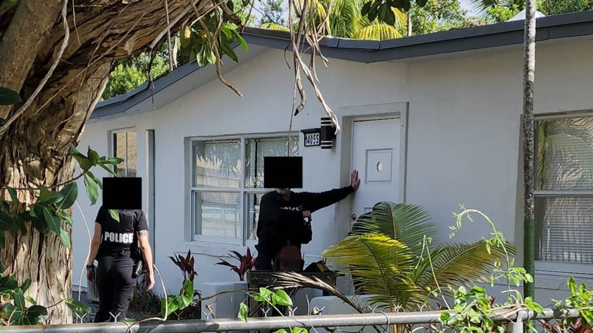 Police at the door of Sam's house.