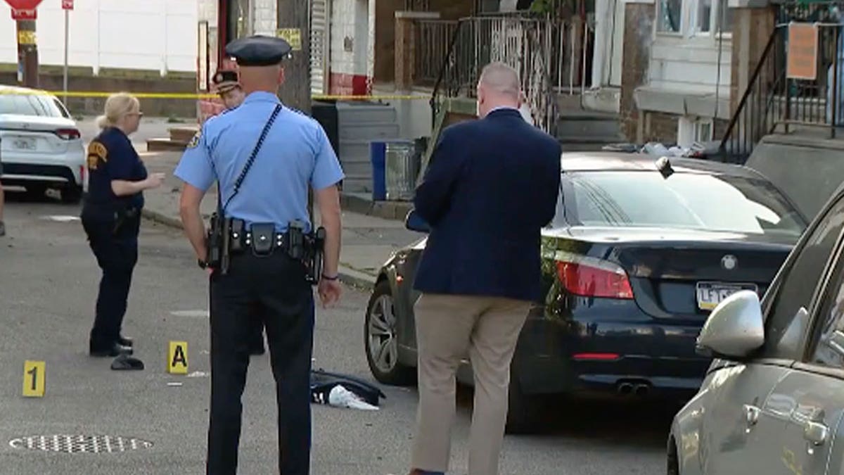 Police investigate the scene of Monday's fatal shooting.